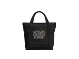 A black tote bag with dual top handles, featuring the text 'ADVOCATE CHRISTIAN ACADEMY' printed on the front in white and gold, set against a plain white background.