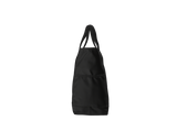 A black fabric utility tote bag with two shoulder straps and a front pocket, shown from the side against a plain white background.