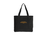 A black tote bag with two handles, featuring a small quote from Ephesians printed in gold. 