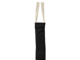 A black fabric shoulder bag with two cream-colored fabric straps, shown from the side against a plain white background.