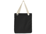 A black canvas tote bag with cream shoulder straps and silver metal grommets, shown against a plain white background.