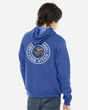 Adult wearing a blue hoodie with the Fairview Sharks round, blue, gray and white logo on the back, against a white background