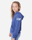 Youth wearing a blue hoodie with 'CHOMP!' printed on the top of the shoulder sleeve against a white background