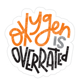 Dye cut motivational decal with 'Oxygen is Overrated' text in orange, gray, and black on a white background