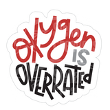 Dye cut motivational decal with 'Oxygen is Overrated' text in red, gray, and black on a white background