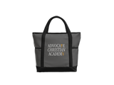 A dark gray tote bag with black handles and base trim, featuring the text 'ADVOCATE CHRISTIAN ACADEMY' printed on the front in white and gold.