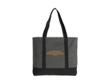 A dark gray tote bag with black handles and a black bottom base, featuring a small quote from Ephesians printed in gold. 